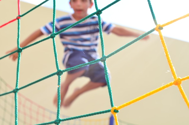 Boy bouncing on trampoline